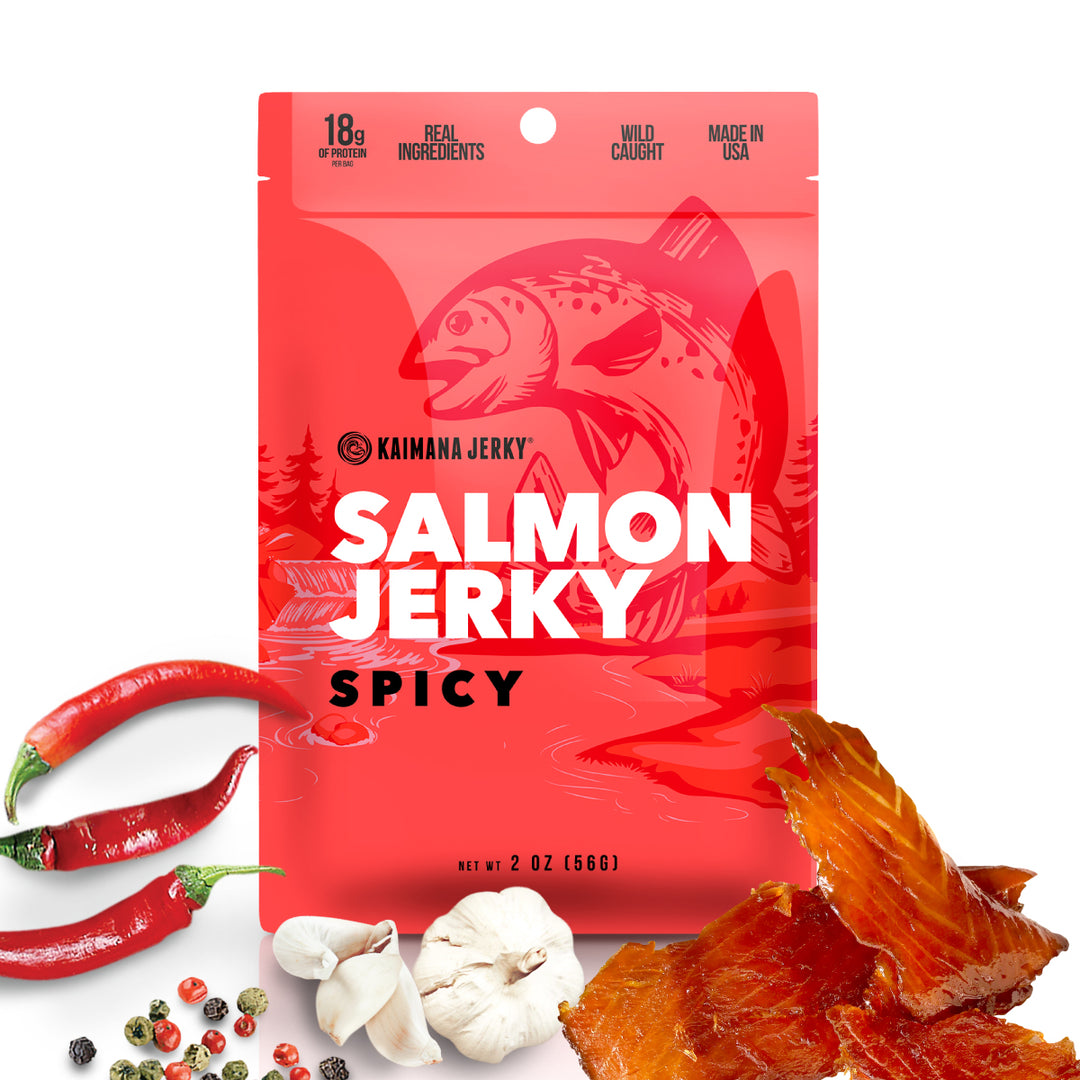 Kaimana Spicy salmon jerky bag front with garlic, black pepper and chili peppers in front alongside jerky